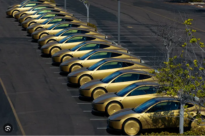 A row of Cybercabs parked at a depot